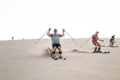 Sandboarding or Sand Ski in Huacachina Apresski bonfire Sunset